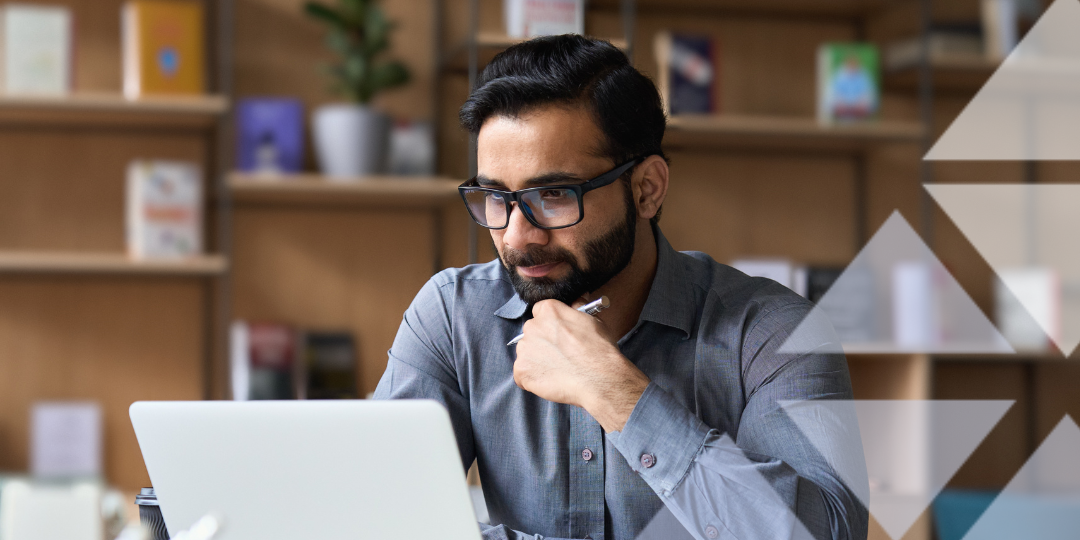 Man taking part in a webinar sat at laptop